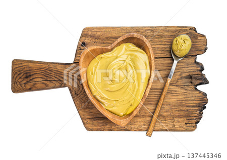 Sweet pistachio cream spread with rich green color served in wooden bowl minimal dessert concept on white background Sweet pistachio cream spread with rich green color served in wooden bowl minimal dessert concept on white background 137445346