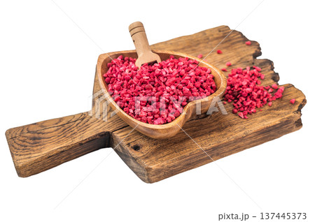 Freeze dried raspberry granules in heart shaped wooden bowl on rustic board. Natural berry ingredient flatlay with copy space 137445373