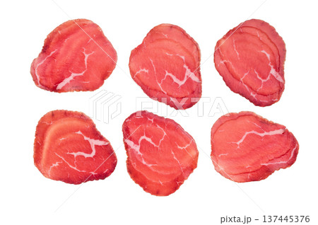 Thin sliced cured beef bresaola, rich red color and delicate marbling on clean white background. Thin sliced cured beef bresaola, rich red color and delicate marbling on clean white background. 137445376