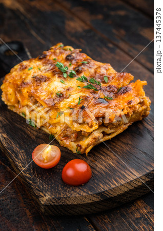Homemade beef lasagna portion with rich bolognese sauce pasta sheets and cheesy crust on rustic board 137445378