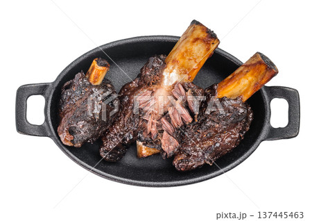 Braised beef ribs with pulled texture and caramelized surface in skillet. Slow cooked beef ribs with plate and back ribs appearance. 137445463