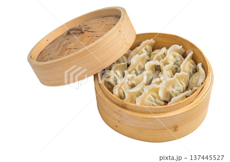 Steamed Asian dumplings mandu served in bamboo steamer on light background ideal for dim sum menus and stock photography. 137445527