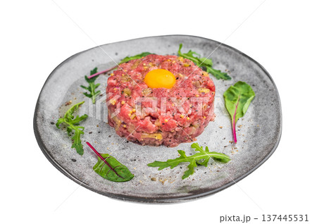 Fresh steak tartare with mustard pickles and herbs served on light plate perfect for fine dining visuals culinary ads and recipe concepts. Fresh steak tartare with mustard pickles and herbs served on light plate perfect for fine dining visuals culinary ads and recipe concepts. 137445531