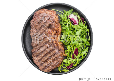 Grilled dry aged striploin steak with fresh arugula salad on a light textured background, juicy beef cooked to perfection for gourmet dishes Grilled dry aged striploin steak with fresh arugula salad on a light textured background, juicy beef cooked to perfection for gourmet dishes 137445544