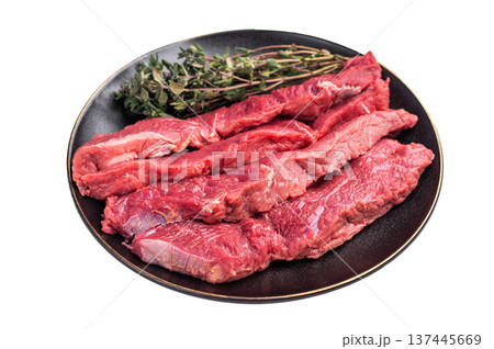 Raw sliced horse meat steaks presented with herbs and spices, inviting creativity in the kitchen for those seeking bold flavors and unique dining experiences. isolated on white background. top view Raw sliced horse meat steaks presented with herbs and spices, inviting creativity in the kitchen for those seeking bold flavors and unique dining experiences. isolated on white background. top view 137445669