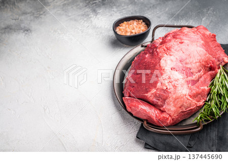 Beautifully arranged raw boneless beef shank pieces on a rustic platter, inviting creativity in the kitchen for delicious slow-cooked meals. grey background. top view 137445690