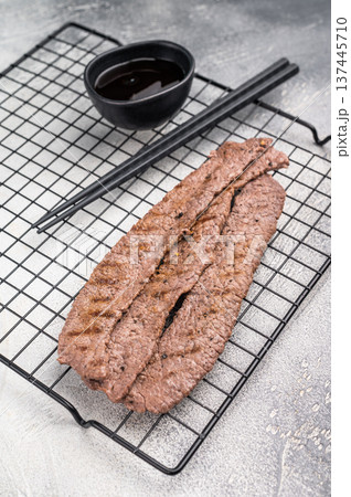 Japanese BBQ yakiniku, grilled wagyu bees strips. grey background. top view 137445710