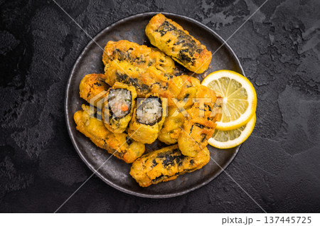 Gimmari or Kimmari, Korean seaweed rolls filled with vermicelli. black background. top view Gimmari or Kimmari, Korean seaweed rolls filled with vermicelli. black background. top view 137445725