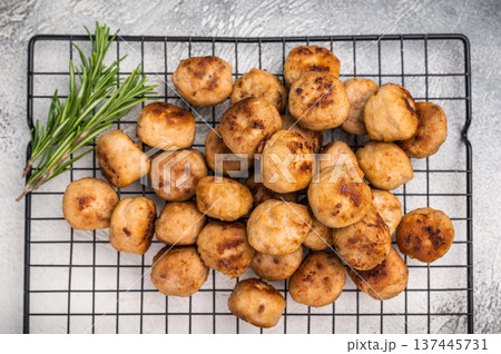 Fried Meatballs from beef and pork minced meat garnished with fresh herbs. grey background. top view Fried Meatballs from beef and pork minced meat garnished with fresh herbs. grey background. top view 137445731