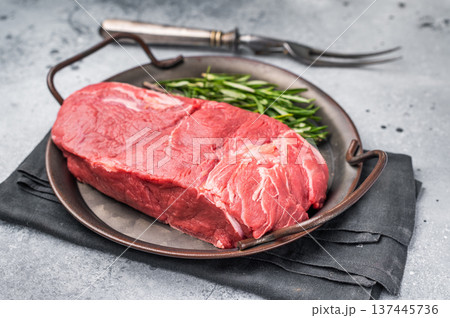 Freshly cut horse meat pieces arranged artfully, showcasing their tender texture and deep red hue, perfect for gourmet recipes. grey background. top view 137445736