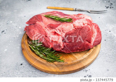 A selection of fresh beef shin, boneless shank meat cuts on a butcher block, emphasizing their quality and versatility for various cooking methods. greybackground. top view A selection of fresh beef shin, boneless shank meat cuts on a butcher block, emphasizing their quality and versatility for various cooking methods. greybackground. top view 137445779