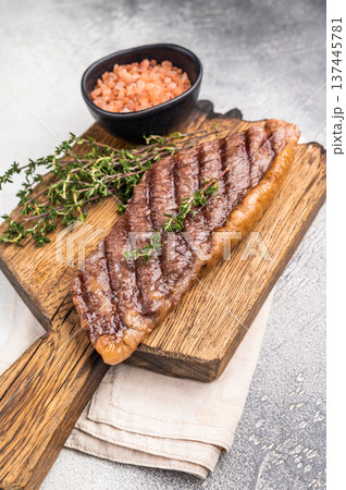 Grilled Top Sirloin, cooked rump beef steak. grey background. top view Grilled Top Sirloin, cooked rump beef steak. grey background. top view 137445781