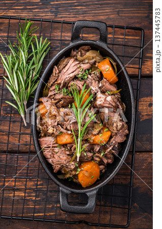 Skillet of beef bourguignon with tender beef, carrots, and mushrooms. wooden background. top view Skillet of beef bourguignon with tender beef, carrots, and mushrooms. wooden background. top view 137445783