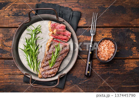 BBQ grilled Top Sirloin beef steak with herbs. wooden background. top view BBQ grilled Top Sirloin beef steak with herbs. wooden background. top view 137445790