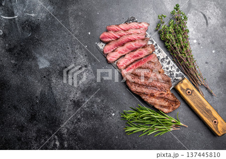 Savory shoulder steak Denver, beautifully cooked on the grill, highlighting its marbled texture and succulent taste. black background. top view Savory shoulder steak Denver, beautifully cooked on the grill, highlighting its marbled texture and succulent taste. black background. top view 137445810