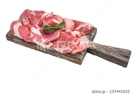 Cured Italian capocollo ham arranged on an aged wooden board with fresh rosemary sprigs on white surface ideal for culinary stock. Cured Italian capocollo ham arranged on an aged wooden board with fresh rosemary sprigs on white surface ideal for culinary stock. 137445832