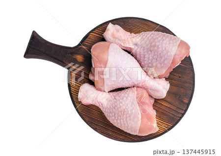 Uncooked poultry drumsticks, raw chicken legs ideal for your favorite recipes, waiting to be seasoned and cooked to perfection. isolated on white background. top view Uncooked poultry drumsticks, raw chicken legs ideal for your favorite recipes, waiting to be seasoned and cooked to perfection. isolated on white background. top view 137445915