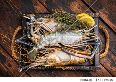 Closeup of raw rosenbergii shrimp prawn showcasing their vibrant color and texture, a must-have for culinary creations. wooden background. top view 137446030