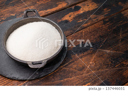 Bright and clean granulated sugar, an essential ingredient for delicious treats and drinks. wooden background. top view 137446031