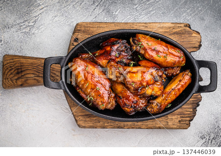 Grilled chicken wings smothered in sweet and sour sauce, poultry meat. white background. top view Grilled chicken wings smothered in sweet and sour sauce, poultry meat. white background. top view 137446039