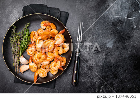 Appetizing grilled shrimp prawns served on a platter, perfect for elegant dinners or casual gatherings with friends. black background. top view Appetizing grilled shrimp prawns served on a platter, perfect for elegant dinners or casual gatherings with friends. black background. top view 137446053