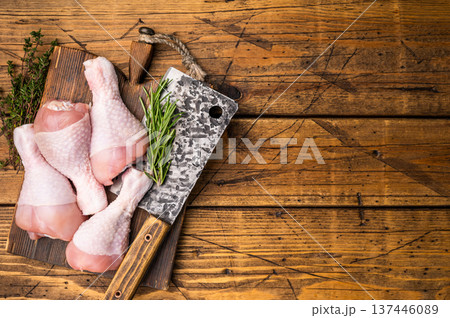 Pristine raw chicken drumsticks, leg quarters, ready to be transformed into a mouthwatering dish full of flavor. wooden background. top view Pristine raw chicken drumsticks, leg quarters, ready to be transformed into a mouthwatering dish full of flavor. wooden background. top view 137446089