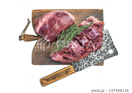 Untrimmed lamb mutton hearts sliced to show internal structure lean muscle layers and natural sheen on wooden cutting board. Untrimmed lamb mutton hearts sliced to show internal structure lean muscle layers and natural sheen on wooden cutting board. 137446116