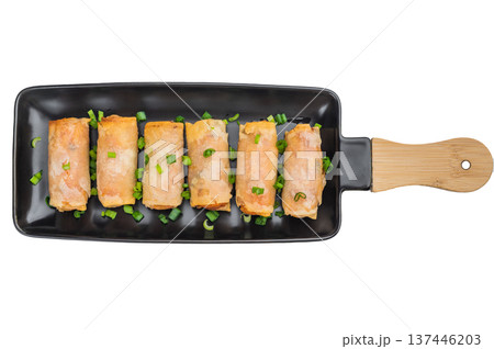 Crispy fried spring rolls Lumpia served on black ceramic plate with green onions Asian appetizer top view 137446203