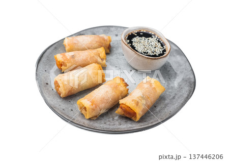 Crispy fried spring rolls served on ceramic plate with soy dipping sauce and sesame seeds on white background Crispy fried spring rolls served on ceramic plate with soy dipping sauce and sesame seeds on white background 137446206