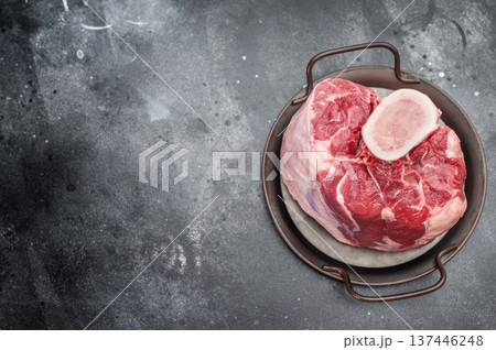 Raw veal shank hock whole piece with bone in cooking pan on stone background premium calf meat for braising and cuisine 137446248