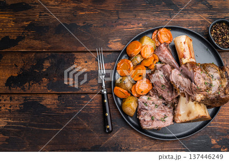 Braised Slow cooked beef osso buco with juicy meat texture marrow bone and roasted vegetables top view 137446249