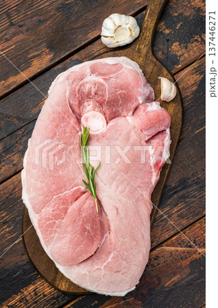 Fresh raw pork shoulder with bone on cutting board wooden background uncooked meat garnished with rosemary for butcher cooking and bbq 137446271