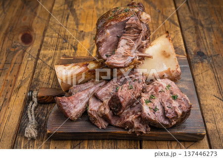 Slow cooked beef ossobuco shank with tender meat texture bone marrow wooden board flat lay Slow cooked beef ossobuco shank with tender meat texture bone marrow wooden board flat lay 137446273