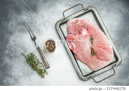 Raw pork shoulder joint with bone on metal pan grey background fresh meat cut for slow cook barbecue pulled pork and cuisine Raw pork shoulder joint with bone on metal pan grey background fresh meat cut for slow cook barbecue pulled pork and cuisine 137446276