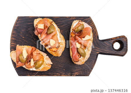 Tapa with Jamon cured ham, parmesan cheese and olives isolated on white background. top view 137446316