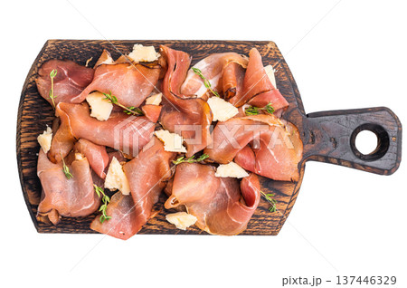 Italian Prosciutto parma ham with herbs and parmesan cheese on wooden board isolated on white background. top view Italian Prosciutto parma ham with herbs and parmesan cheese on wooden board isolated on white background. top view 137446329
