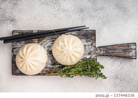 Traditional Dumpling Momos with meat on wooden board. white background. top view Traditional Dumpling Momos with meat on wooden board. white background. top view 137446336