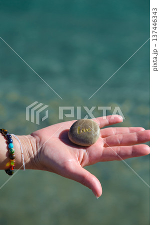 a stone with the inscription love in hand a stone with the inscription love in hand 137446343