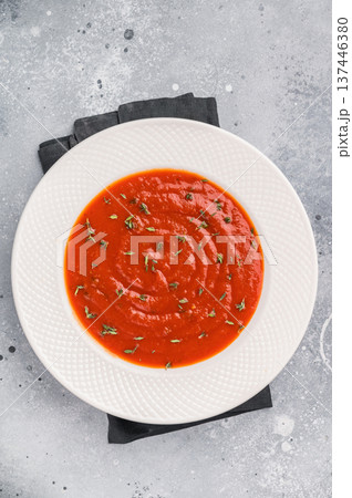 Tomato soup with thyme in plate. grey background. top view 137446380
