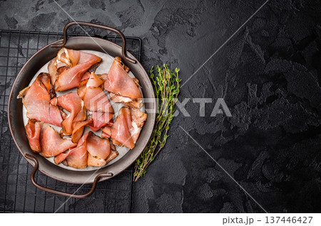 Italian Cured Prosciutto crudo ham. black background. top view Italian Cured Prosciutto crudo ham. black background. top view 137446427
