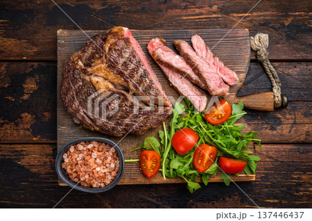 BBQ Grilled Rib eye steak on wooden board, roast beef meat. wooden background. top view BBQ Grilled Rib eye steak on wooden board, roast beef meat. wooden background. top view 137446437