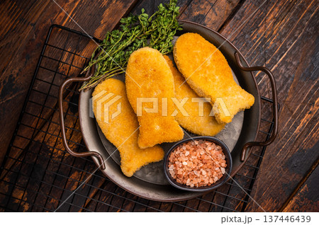 Fish fingers or fish sticks on steel tray. wooden background. top view Fish fingers or fish sticks on steel tray. wooden background. top view 137446439
