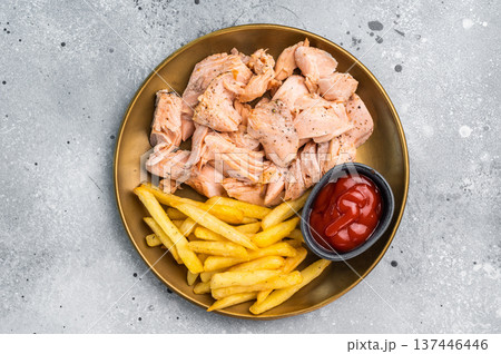 Dinner with Pulled salmon roast fillets and french fry on a plate. gray background. Top view 137446446