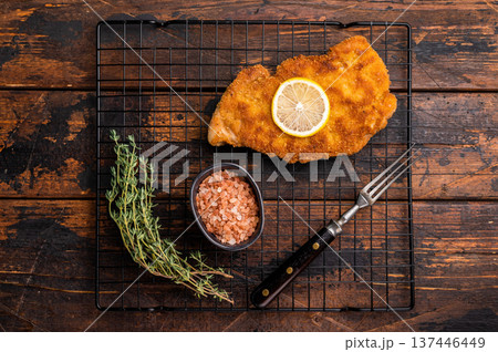 Fried Wiener chicken schnitzel steak, breaded meat. wooden background. top view Fried Wiener chicken schnitzel steak, breaded meat. wooden background. top view 137446449