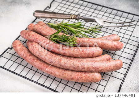 Fresh raw sausage links ready for grilling, perfect for barbecues or hearty family meals..white background. top view Fresh raw sausage links ready for grilling, perfect for barbecues or hearty family meals..white background. top view 137446491