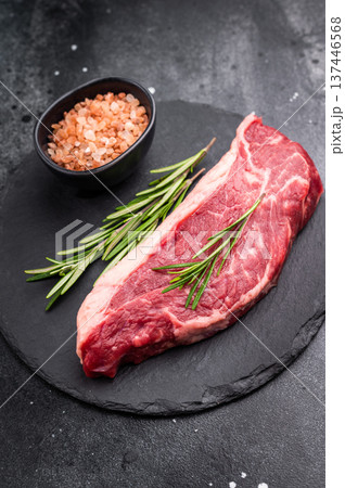 Fresh raw striploin New York steak, perfect for grilling or pan searing, ideal for a delicious homemade meal. black background. top view Fresh raw striploin New York steak, perfect for grilling or pan searing, ideal for a delicious homemade meal. black background. top view 137446568