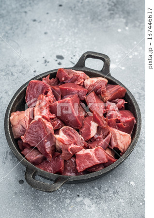 Diced lamb and goat hearts in a castiron skillet on a rustic board, perfect for hearty stews, braising and rich offal recipes. Diced lamb and goat hearts in a castiron skillet on a rustic board, perfect for hearty stews, braising and rich offal recipes. 137446617