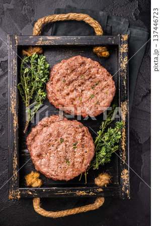 Grilled hamburger mince meat patties with herbs. black background. top view Grilled hamburger mince meat patties with herbs. black background. top view 137446723