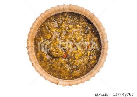Traditional green Chutney condiment in wooden bamboo bowl isolated on white background overhead view Traditional green Chutney condiment in wooden bamboo bowl isolated on white background overhead view 137446760
