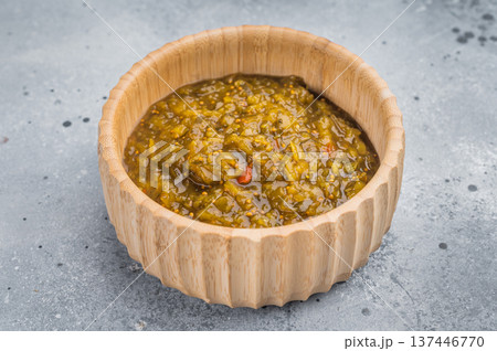 Homemade green Chutney with rich texture in bamboo bowl on gray background studio shot Homemade green Chutney with rich texture in bamboo bowl on gray background studio shot 137446770